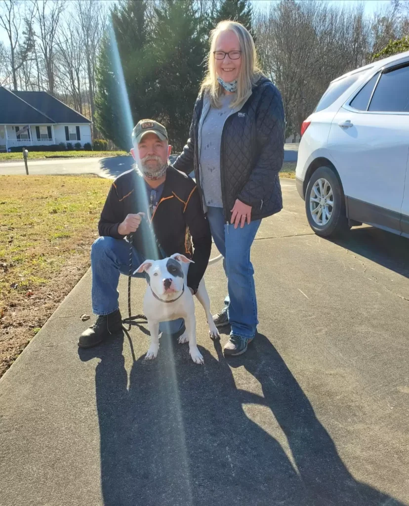 The dog is pictured with her new family.