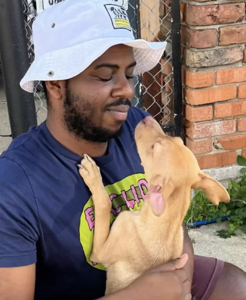 Close-up of man saying goodbye to dog he rescued.